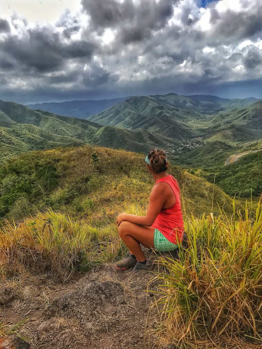 Sitting above a valley of green mountains
