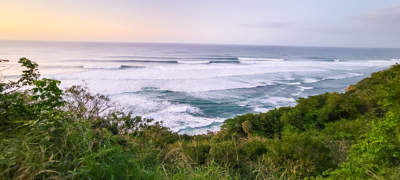 Surf lineup at sunset