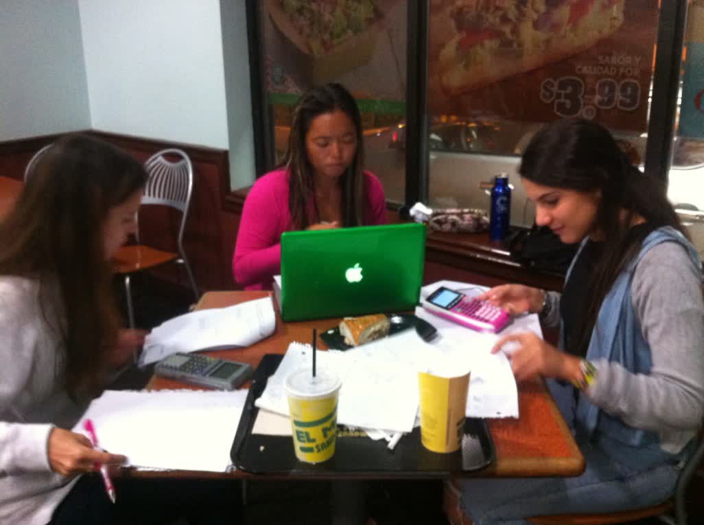 Miriam working through problem sets with two students